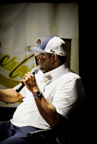 Behind the scenes at RRL 2026, guest in blue-and-white trucker cap speaking into mic, seated in profile on set