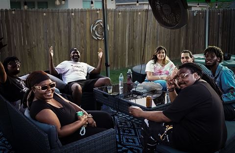 Behind the scenes at RRL 2026, group relaxing on the patio couches under string lights