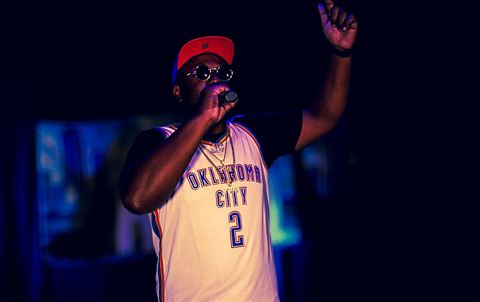 Big Tree #4real at RRL 2026, in red cap and Oklahoma City jersey with one arm raised while rapping