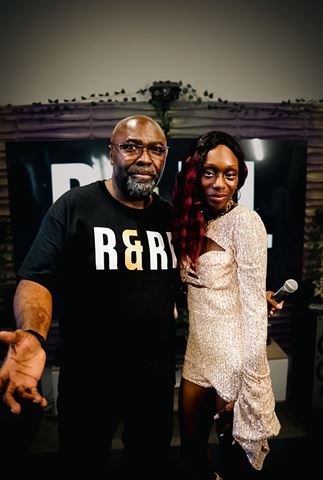 Ife Devine and Mr Durite at RRL 2026, host posing beside artist in sequined outfit holding the mic