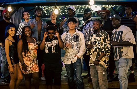 RRL 2026 Lineup, the RRL 2026 lineup posing together under string lights on the covered patio stage