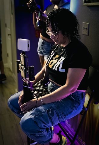 RRL Crew, crew member operating a phone rig with light panel in the purple-lit hallway