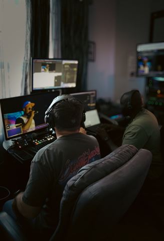 RRL Crew, two crew members in headphones at the multi-monitor livestream station